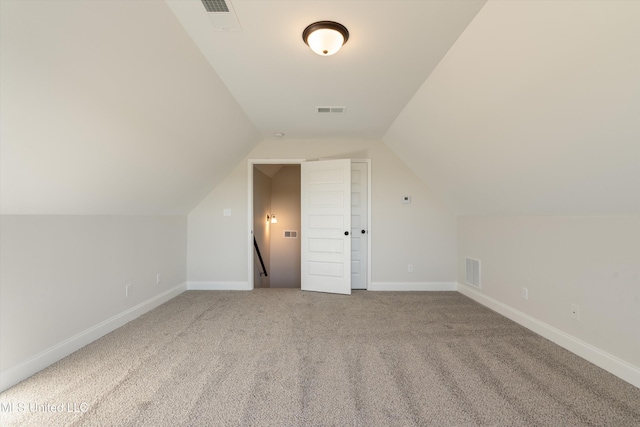 bonus room featuring lofted ceiling, carpet, visible vents, and baseboards