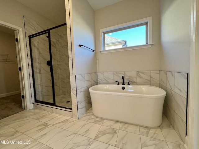 bathroom with tile walls and plus walk in shower