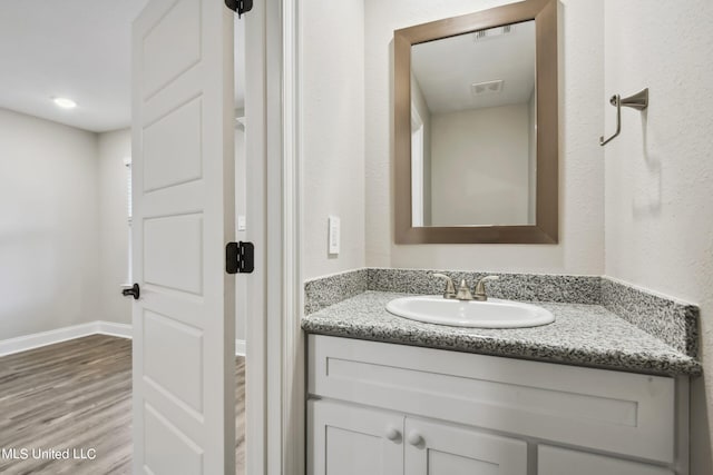 bathroom with vanity and wood-type flooring