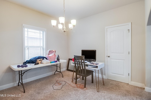 home office with carpet flooring and an inviting chandelier