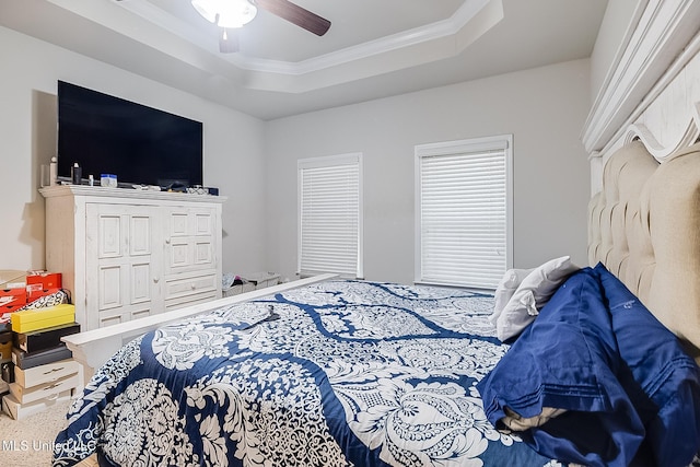 bedroom with a tray ceiling, ceiling fan, and crown molding