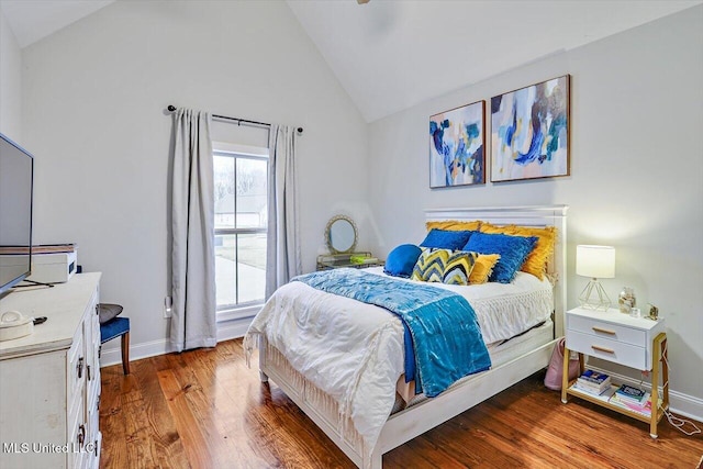 bedroom with wood-type flooring and lofted ceiling