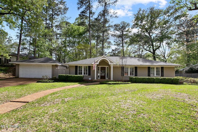 ranch-style house featuring a front lawn and a garage