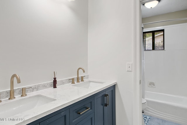 full bathroom featuring bathtub / shower combination, vanity, and toilet