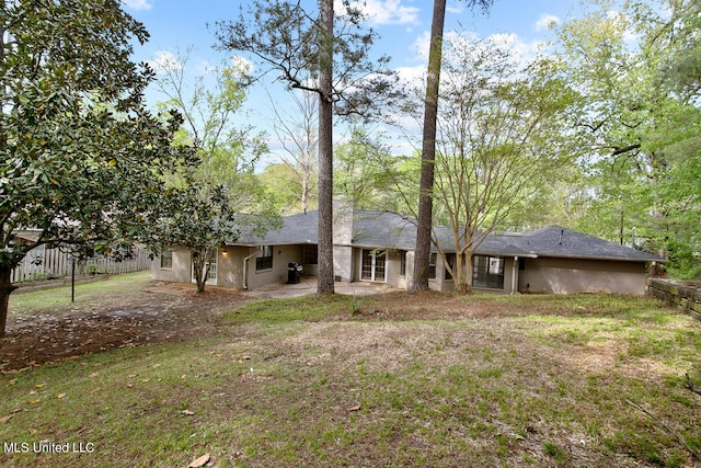 exterior space featuring a patio area and a lawn