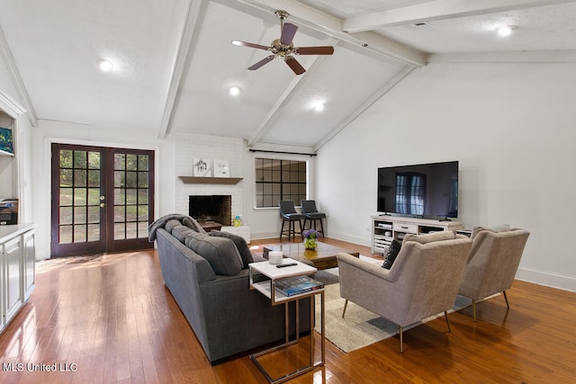 living room with french doors, ceiling fan, hardwood / wood-style flooring, and beamed ceiling