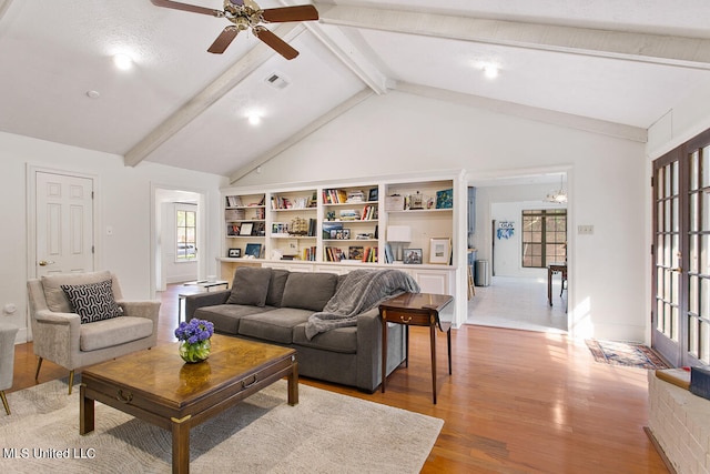 living room featuring beamed ceiling, hardwood / wood-style floors, a textured ceiling, high vaulted ceiling, and ceiling fan