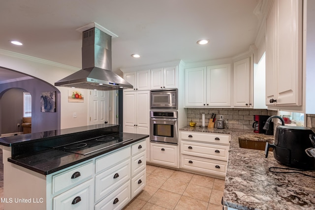 211 Traceway Dr, Natchez, MS 39120 - kitchen featuring stainless steel appliances, island range hood, crown molding, arched walkways, and white cabinetry
