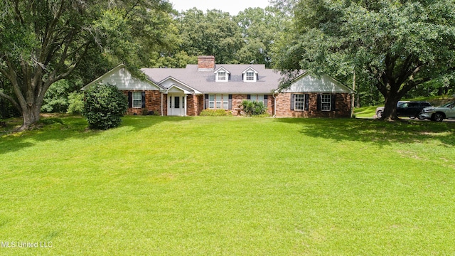 211 Traceway Dr, Natchez, MS 39120 - view of front of home featuring a chimney, a front lawn, and brick siding