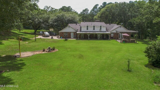 211 Traceway Dr, Natchez, MS 39120 - rear view of house with a patio, a pergola, a lawn, a metal roof, and view of scattered trees