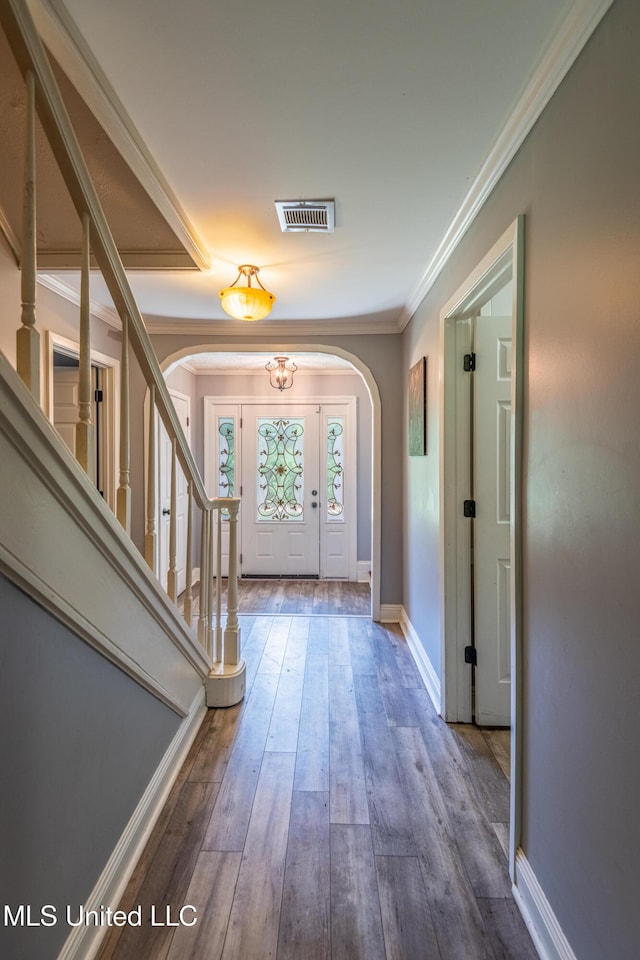 211 Traceway Dr, Natchez, MS 39120 - foyer featuring arched walkways, crown molding, wood finished floors, and stairs