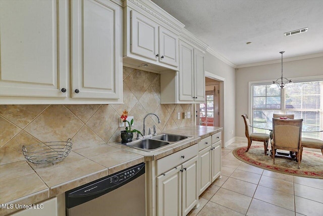 kitchen featuring stainless steel dishwasher, tile counters, plenty of natural light, and sink