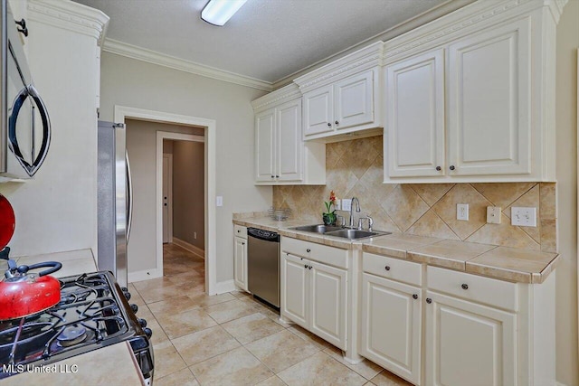 kitchen with crown molding, decorative backsplash, sink, and stainless steel appliances