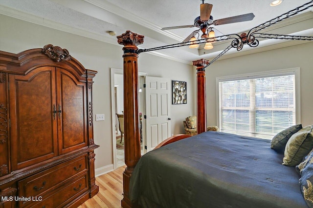 bedroom featuring ceiling fan, light wood-type flooring, a textured ceiling, and ornamental molding