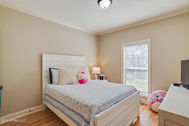 bedroom with hardwood / wood-style flooring and ornamental molding