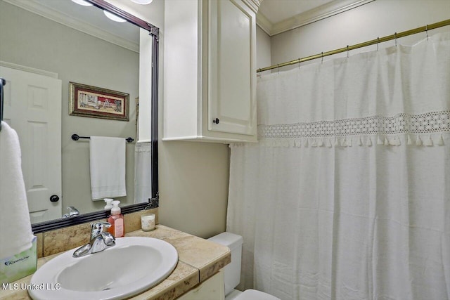 bathroom with crown molding, vanity, and toilet