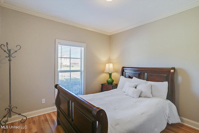 bedroom with light hardwood / wood-style flooring and ornamental molding