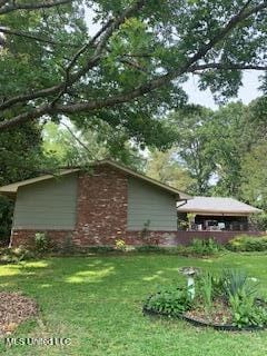 1030 Adkins Blvd, Jackson, MS 39211 - view of property exterior featuring a yard and brick siding