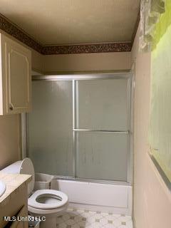 1030 Adkins Blvd, Jackson, MS 39211 - full bathroom with vanity, toilet, combined bath / shower with glass door, and tile patterned floors