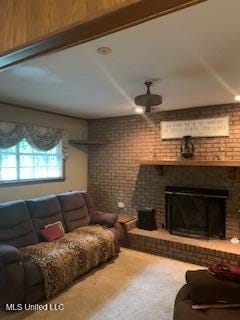 1030 Adkins Blvd, Jackson, MS 39211 - carpeted living room featuring a brick fireplace and ceiling fan