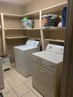 1030 Adkins Blvd, Jackson, MS 39211 - laundry area with washing machine and dryer and light tile patterned floors