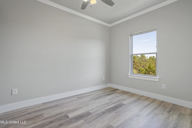 empty room featuring crown molding, a ceiling fan, baseboards, and wood finished floors