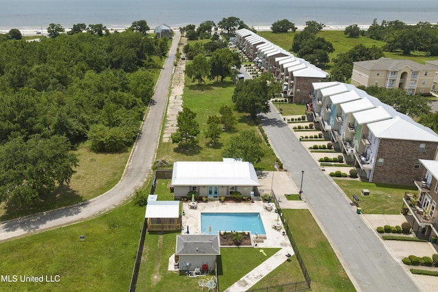 drone / aerial view of a pool and a large body of water