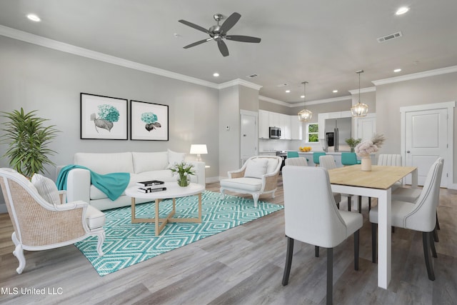dining space featuring recessed lighting, wood finished floors, ceiling fan, and ornamental molding