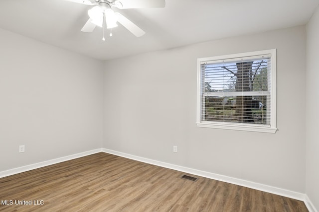 spare room featuring wood-type flooring and ceiling fan