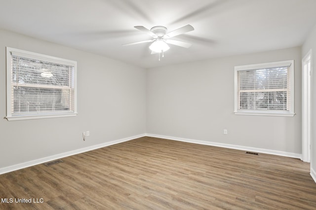 empty room featuring hardwood / wood-style flooring and ceiling fan