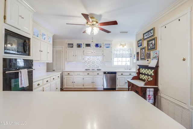 kitchen featuring a ceiling fan, visible vents, a sink, black appliances, and light countertops