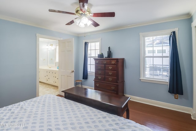 bedroom featuring multiple windows, wood finished floors, baseboards, and ornamental molding