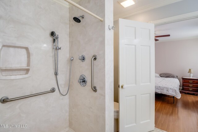 bathroom with walk in shower, ensuite bathroom, wood finished floors, ornamental molding, and ceiling fan