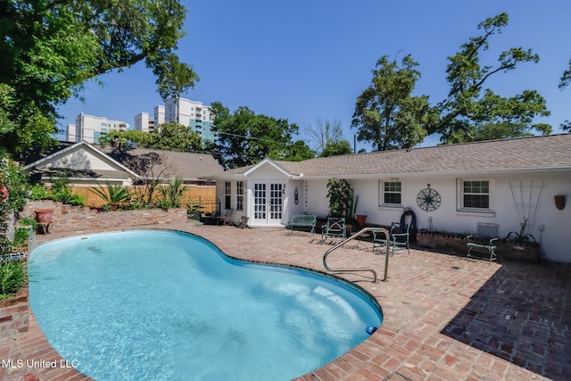 view of pool with a patio, french doors, fence, and a fenced in pool