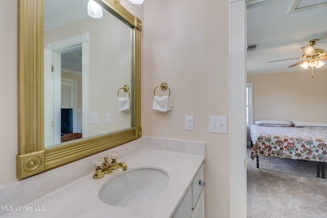 bathroom with ornamental molding, ensuite bathroom, ceiling fan, visible vents, and vanity