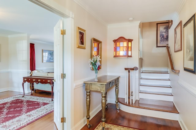 hall with stairs, crown molding, and wood finished floors