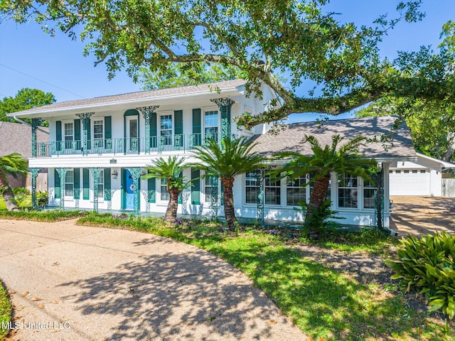 colonial-style house with covered porch and a balcony