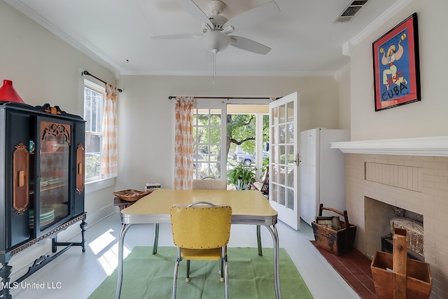 dining room with a fireplace and ornamental molding