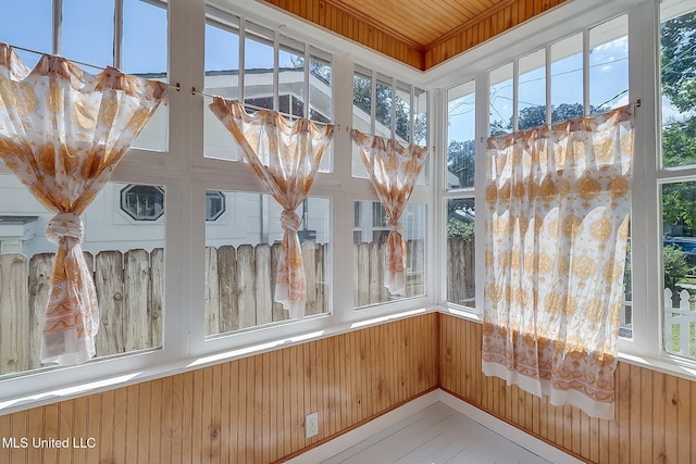 unfurnished sunroom featuring wood ceiling