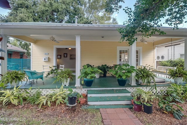 view of exterior entry with ceiling fan and covered porch