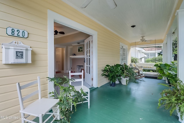 view of patio featuring ceiling fan and a porch