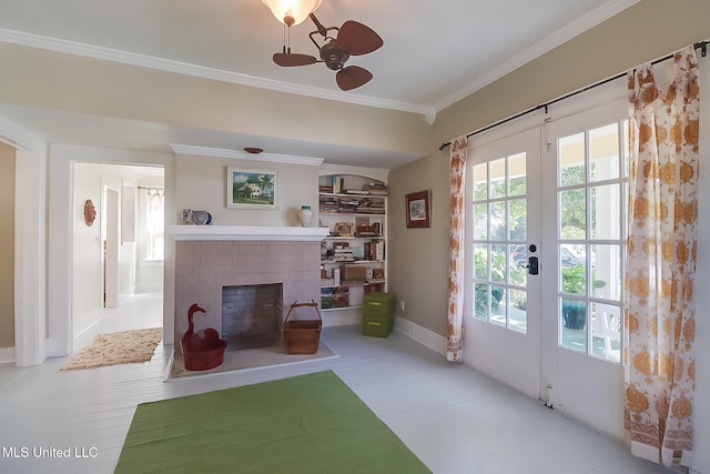 interior space featuring crown molding, a fireplace, french doors, and ceiling fan