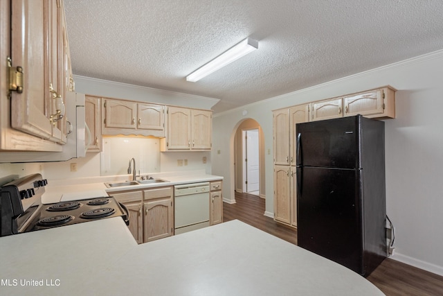 kitchen with freestanding refrigerator, dishwasher, a sink, electric stove, and arched walkways