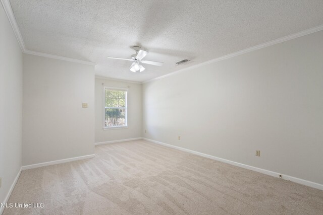empty room with ornamental molding, a ceiling fan, light colored carpet, a textured ceiling, and baseboards