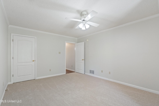 unfurnished bedroom with crown molding, carpet, baseboards, a ceiling fan, and a textured ceiling
