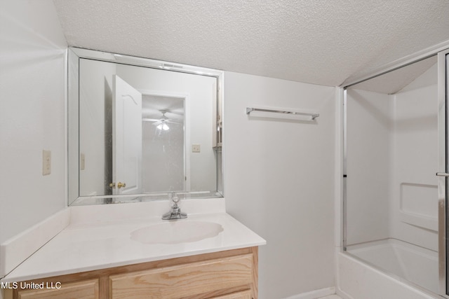full bathroom with a textured ceiling, vanity, and a ceiling fan