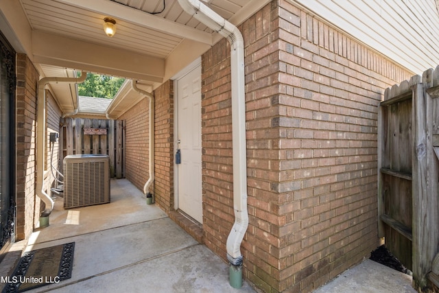 view of property exterior with central AC unit and brick siding