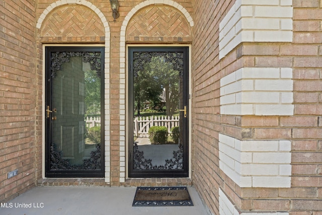 entrance to property with brick siding