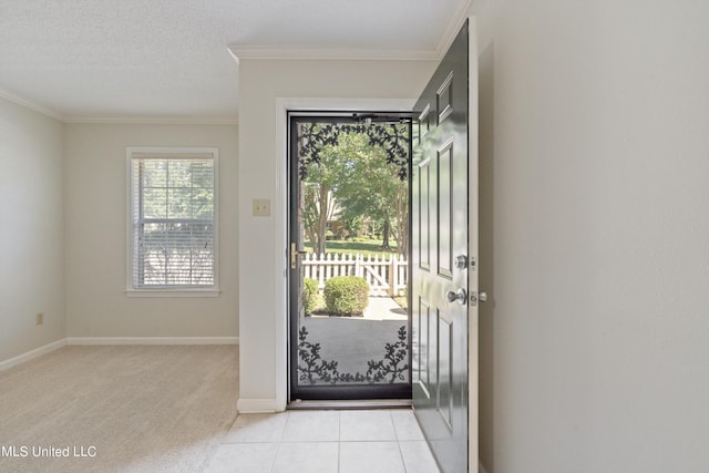 entryway featuring crown molding, baseboards, and light carpet