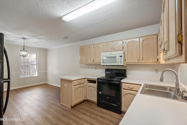 kitchen featuring pendant lighting, black appliances, sink, kitchen peninsula, and light brown cabinets